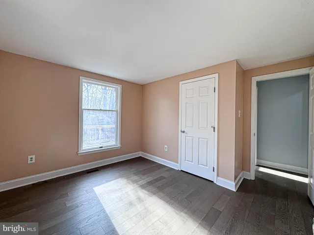 a view of a deck with chairs and wooden floor