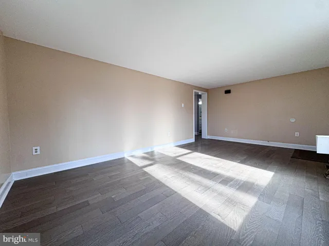 a view of room and hall with a ceiling fan