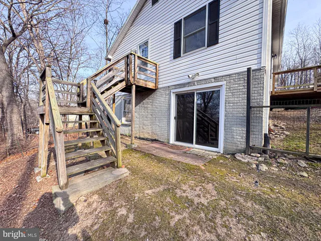 a view of balcony with wooden floor and fence