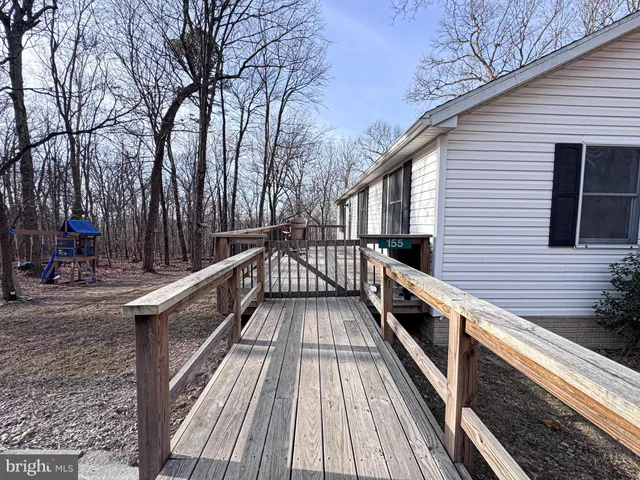 a roof deck with table and chairs and potted plants
