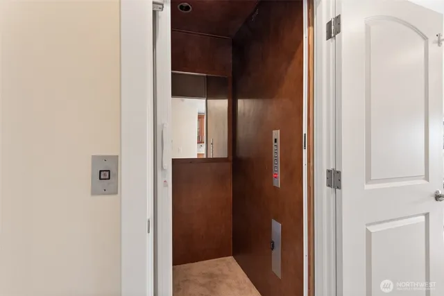 a living room with fireplace furniture and a large window