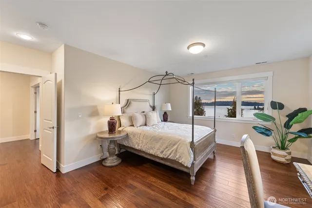a spacious bedroom with a bed and glass window