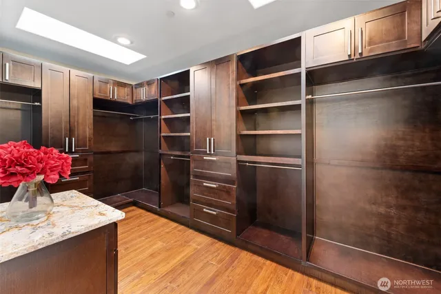 a bathroom with a granite countertop sink mirror and bathtub