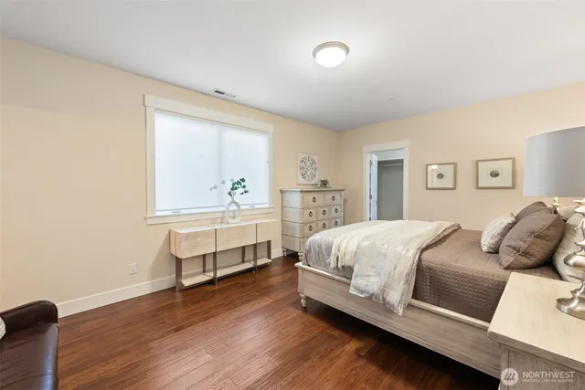 a bedroom with furniture and a large window
