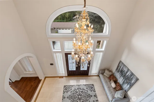 a large kitchen with kitchen island a large window a sink and living room view