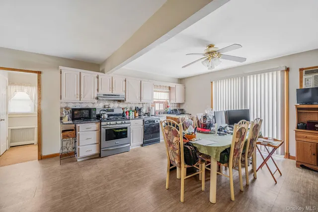 a view of a dining room with furniture and a kitchen
