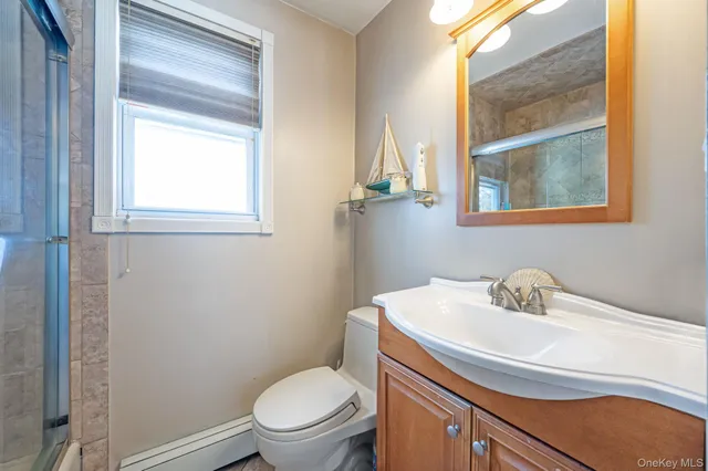 a bathroom with a sink a toilet and a window