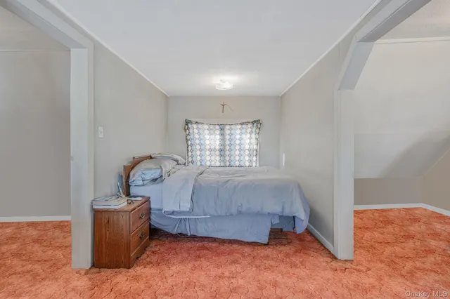 a bed sitting in a room next to a window