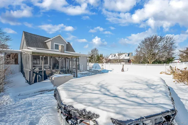a view of a house with yard and sitting area