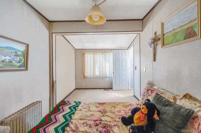 a bedroom with bed and a window