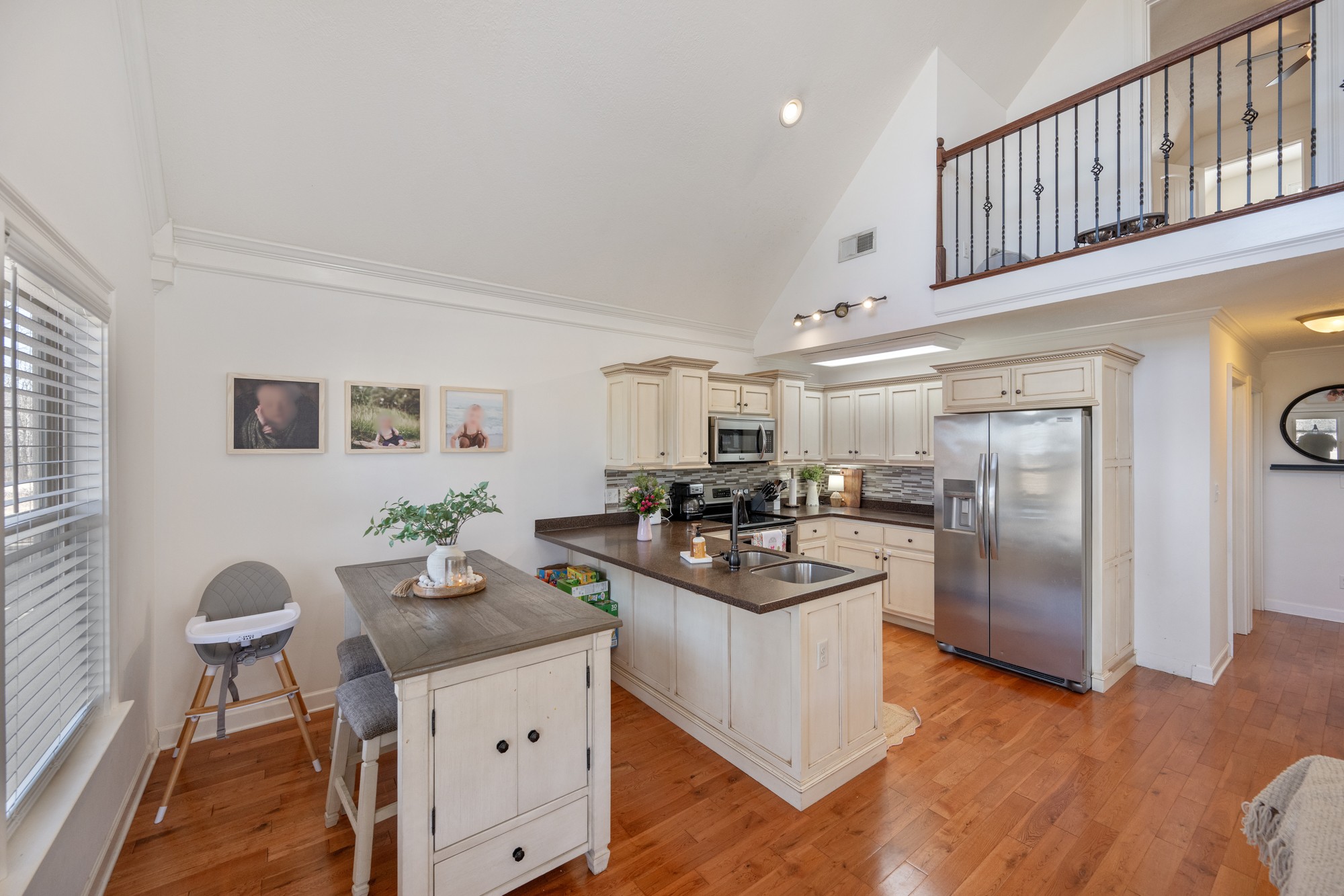 222 Fairway Villa Lane Decaturville, TN 38329 - Photo 12 of 36 a kitchen with stainless steel appliances granite countertop a refrigerator a stove a sink a dining table and chairs with wooden floor