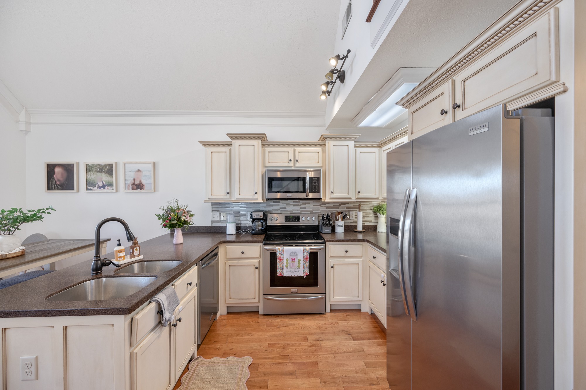 222 Fairway Villa Lane Decaturville, TN 38329 - Photo 13 of 36 a kitchen with stainless steel appliances kitchen island granite countertop a refrigerator and a sink