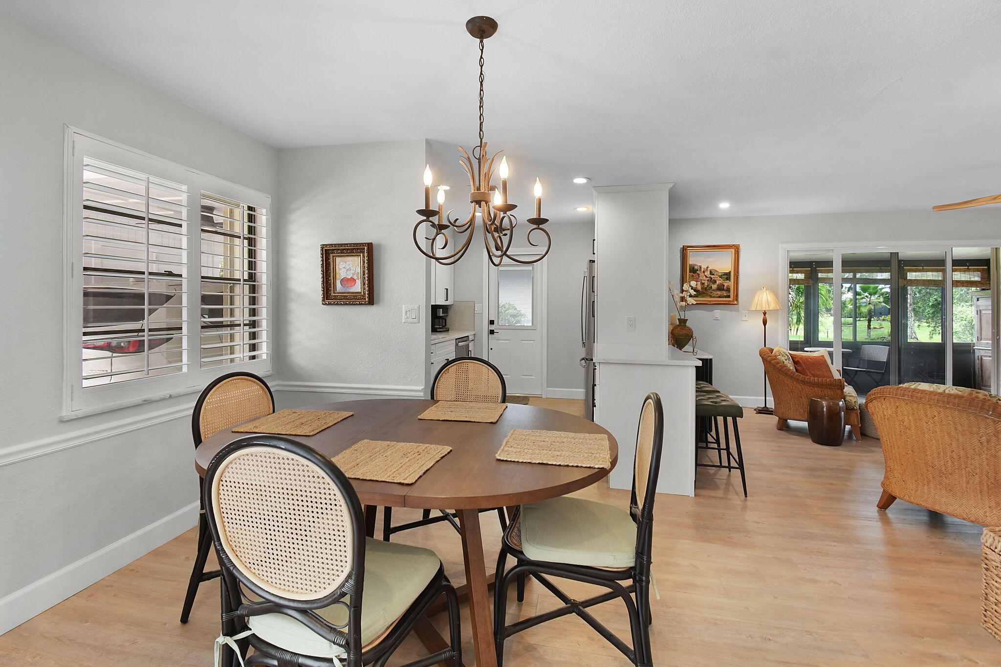 5251 Southeast Sea Island Way Stuart, FL 34997 - Photo 4 of 68 a dining room with furniture a chandelier and wooden floor