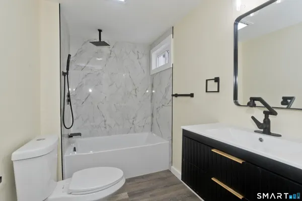 a bathroom with a sink a toilet and a bathtub