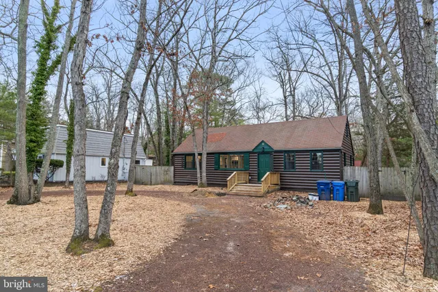 a view of a house with a yard covered in snow