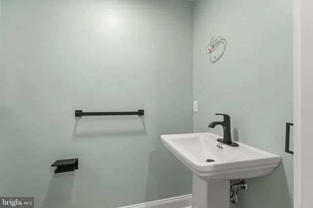 a bathroom with a sink and mirror