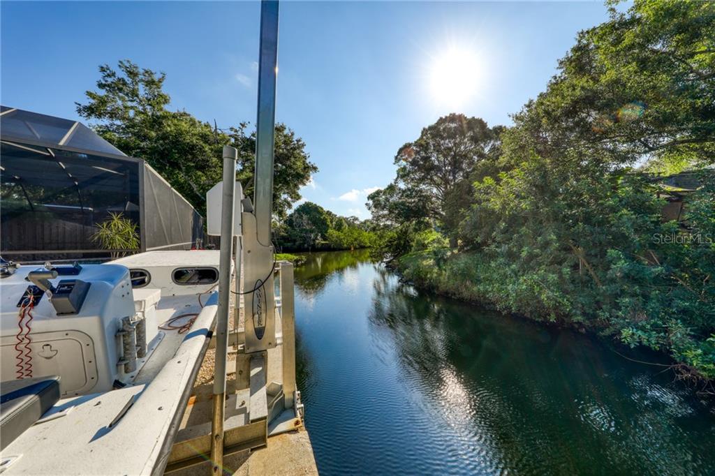 3108 Honeysuckle Road Largo, FL 33770 - Photo 1 of 1 a view of a lake with a palm tree