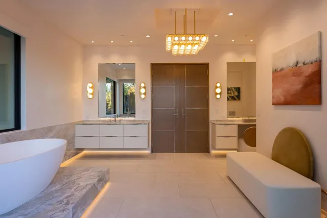 a spacious bathroom with a bathtub a sink and a shower