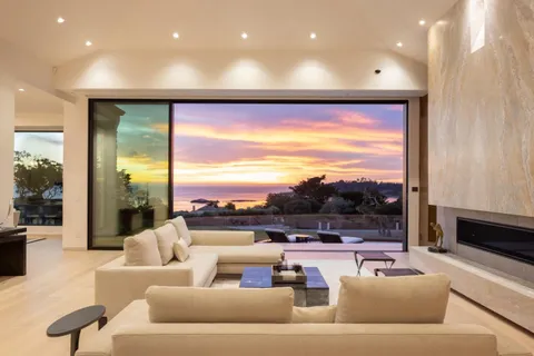 a living room with furniture and a floor to ceiling window