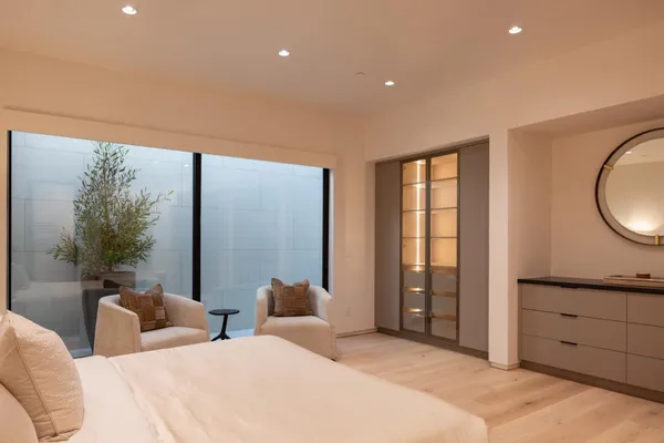 a bedroom with a bed and a painting