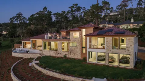 a view of a rooftop deck with couch and chairs