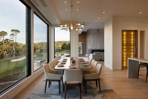 a dining room with furniture a chandelier and wooden floor