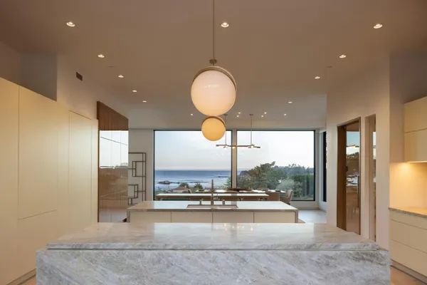 a view of a lobby with a floor to ceiling window and glass door