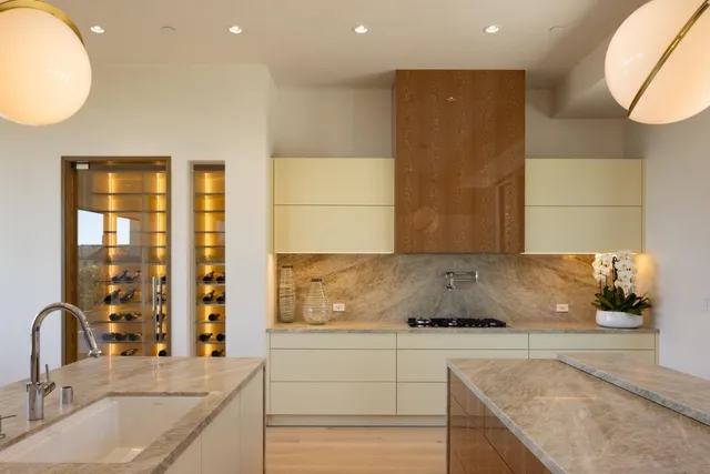 a kitchen with stainless steel appliances granite countertop a sink and a granite counter tops