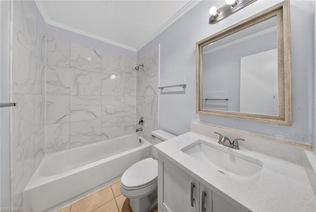 5300 Treetops Drive, Unit I206 Naples, FL 34113 - Photo 11 of 17 a bathroom with a sink toilet and shower