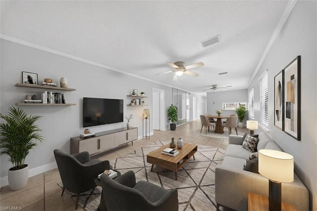 5300 Treetops Drive, Unit I206 Naples, FL 34113 - Photo 16 of 17 a living room with furniture and a flat screen tv