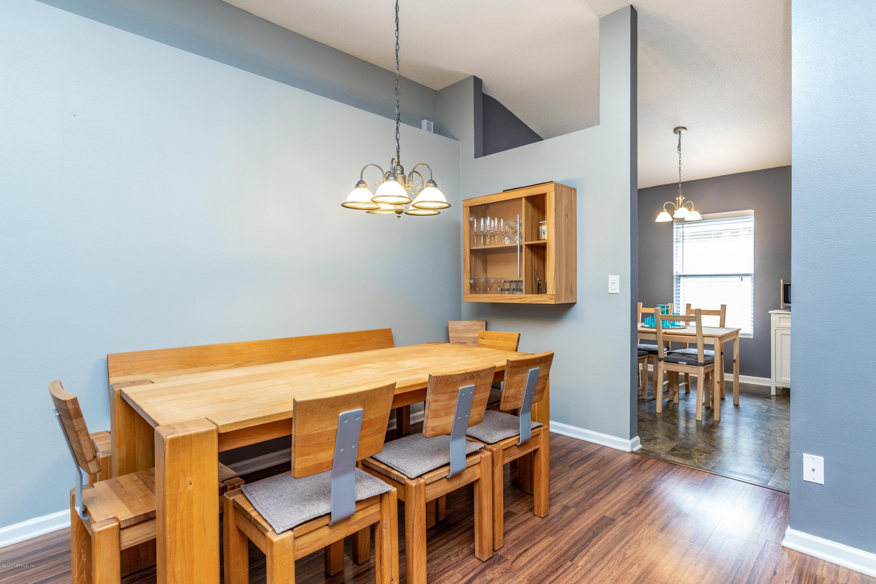 816 Crystal Spring Way St. Augustine, FL 32092 - Photo 11 of 44 a view of a dining room with furniture and wooden floor