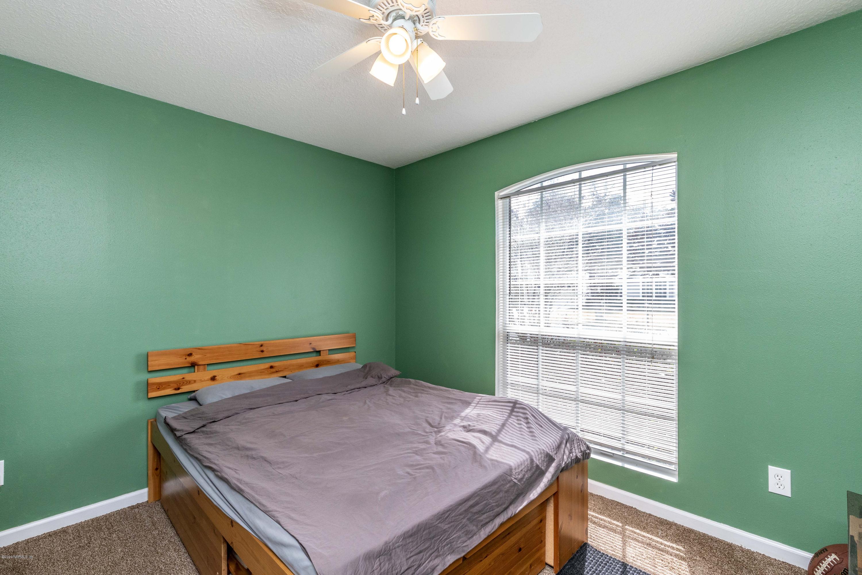 816 Crystal Spring Way St. Augustine, FL 32092 - Photo 21 of 44 a bedroom with a bed and a window