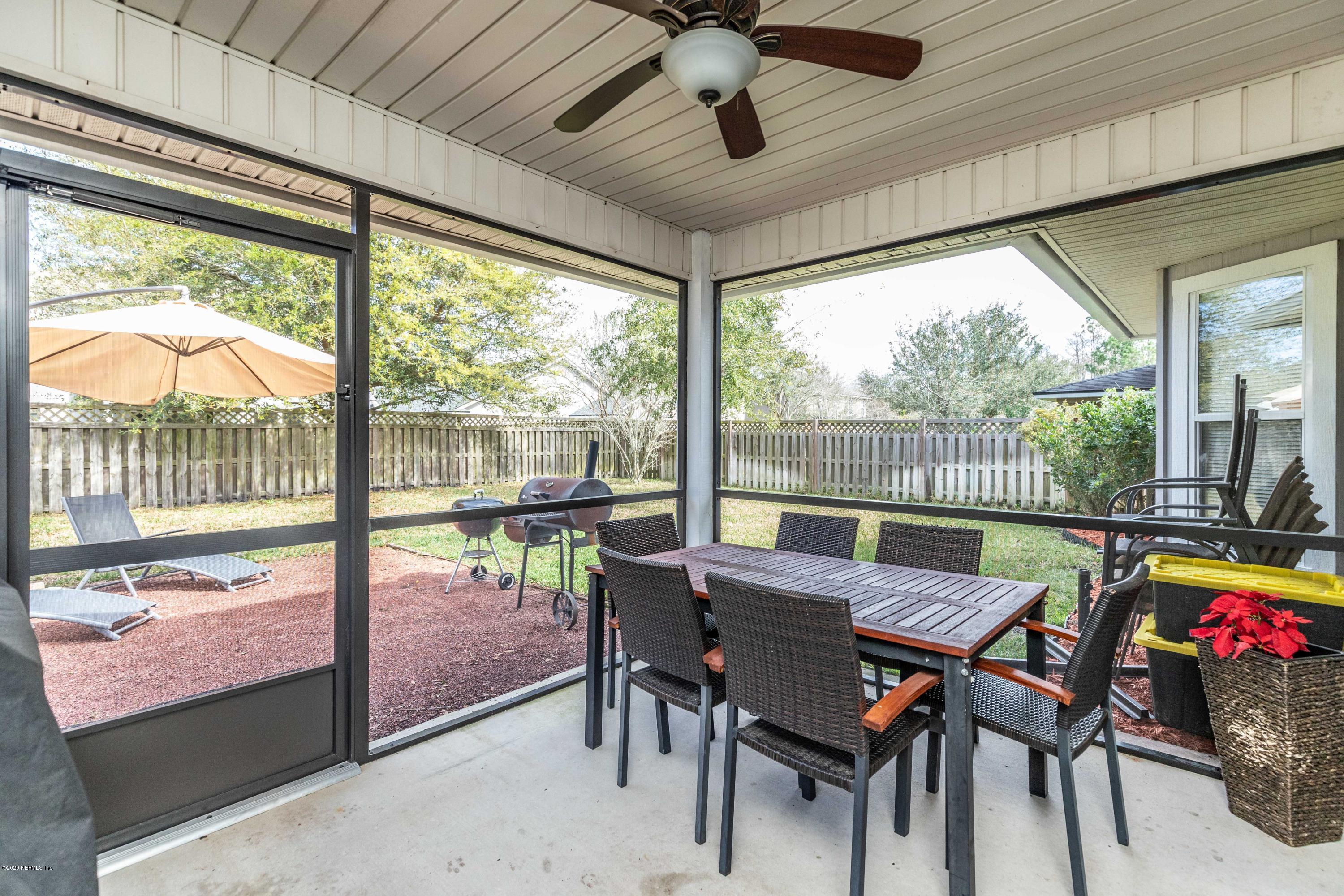 816 Crystal Spring Way St. Augustine, FL 32092 - Photo 26 of 44 a view of a dining room with furniture wooden floor and a potted plant