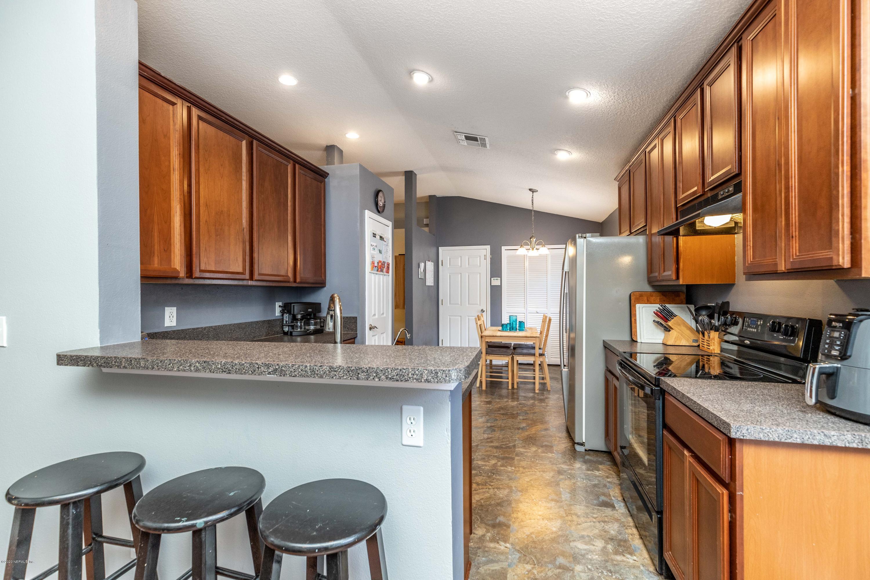 816 Crystal Spring Way St. Augustine, FL 32092 - Photo 6 of 44 a kitchen with cabinets and chairs