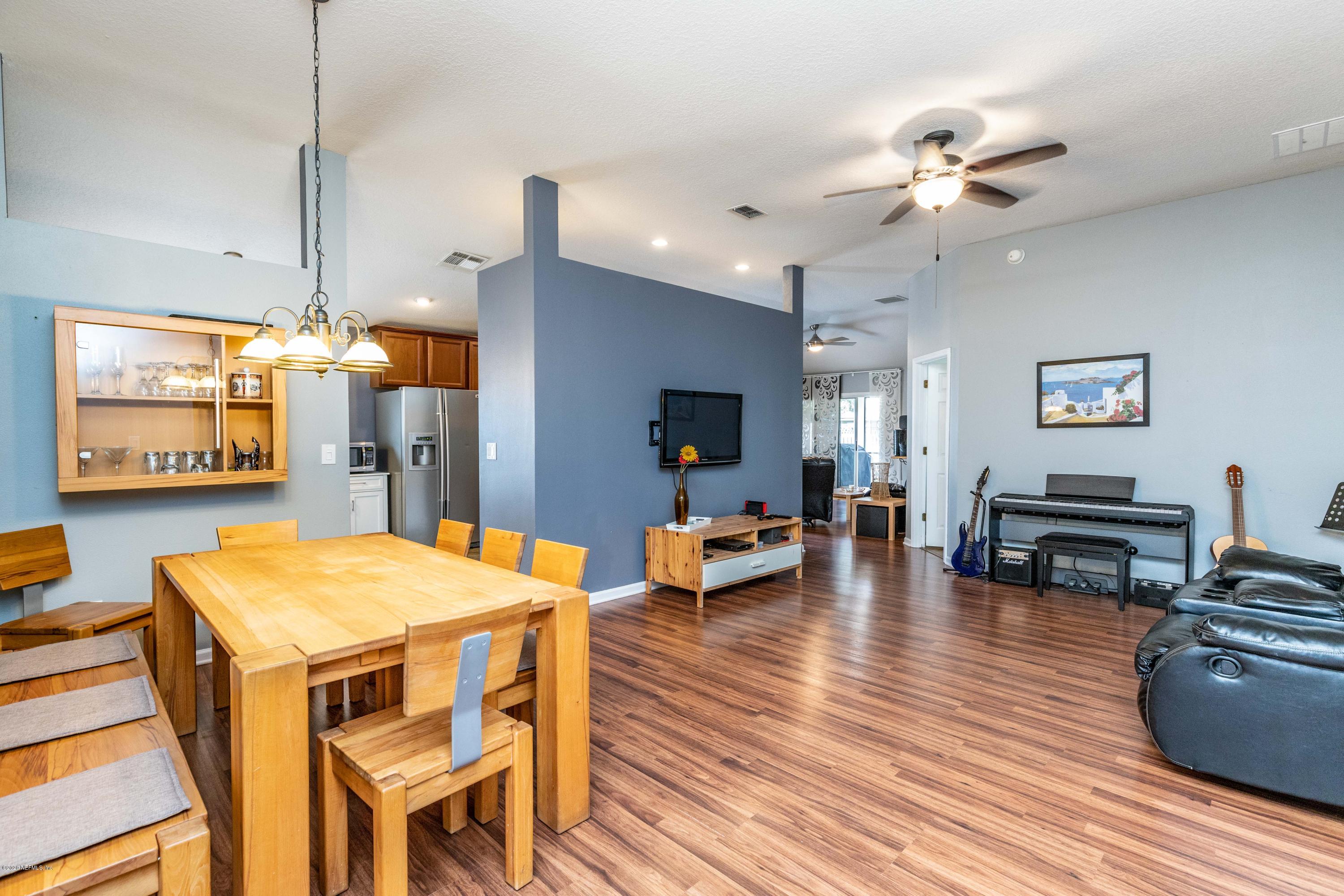 816 Crystal Spring Way St. Augustine, FL 32092 - Photo 9 of 44 a view of a dining room with furniture and wooden floor