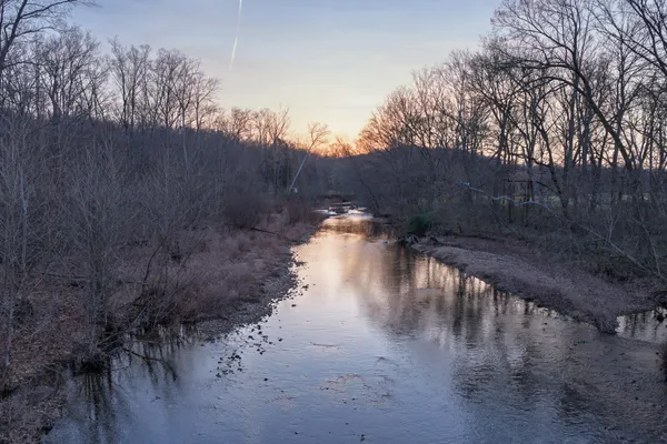a view of a backyard of a house with a lake view