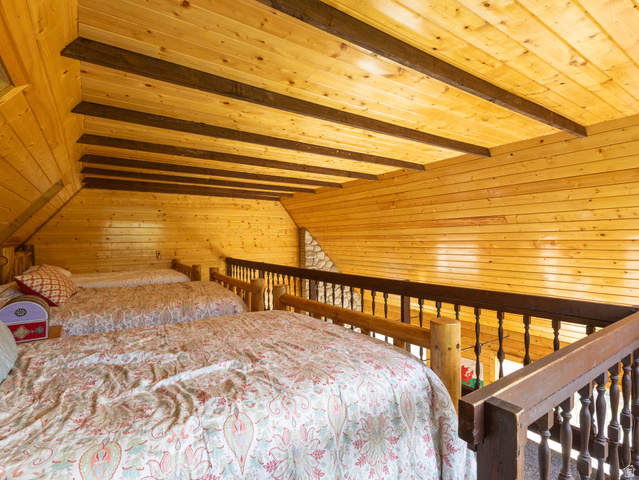 4770 Pine Crest Road Evanston, UT 82930 - Photo 13 of 24 Exposed wood beam ceiling in a loft space with natural wood plank walls