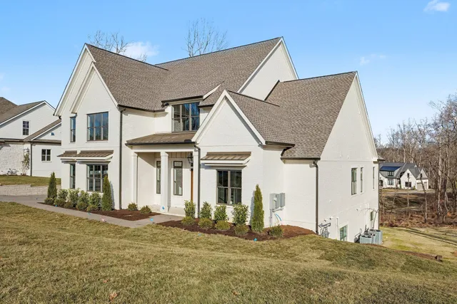 a view of a hallway with wooden floor and entryway