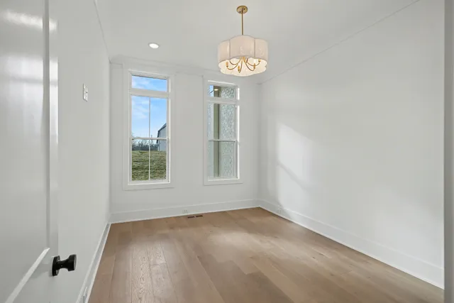 a bathroom with a sink a light fixture and a mirror