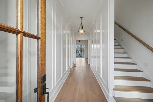 a view of a hallway with wooden floor