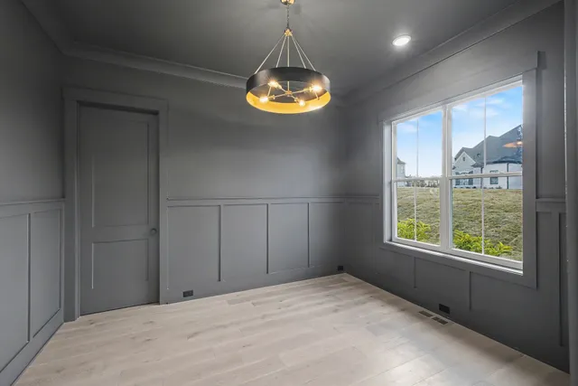 a large kitchen with stainless steel appliances a large counter top