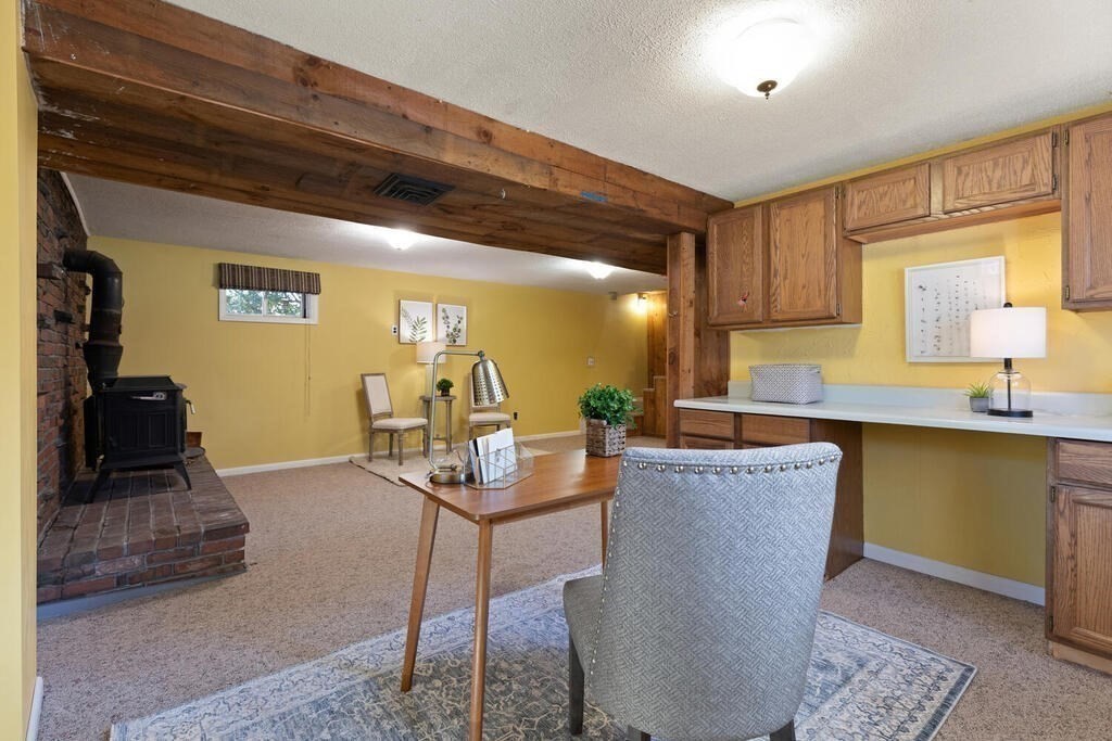 34 Locust Street Burlington, MA 01803 - Photo 19 of 24 a living room with furniture a flat screen tv and a large window