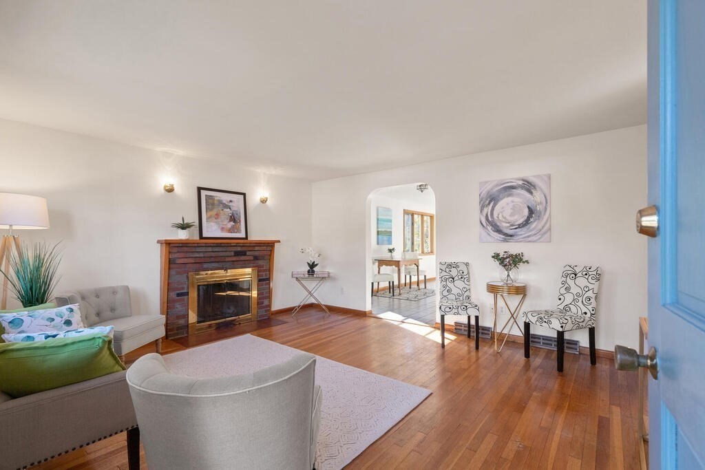 34 Locust Street Burlington, MA 01803 - Photo 3 of 24 a living room with furniture a fireplace and a table