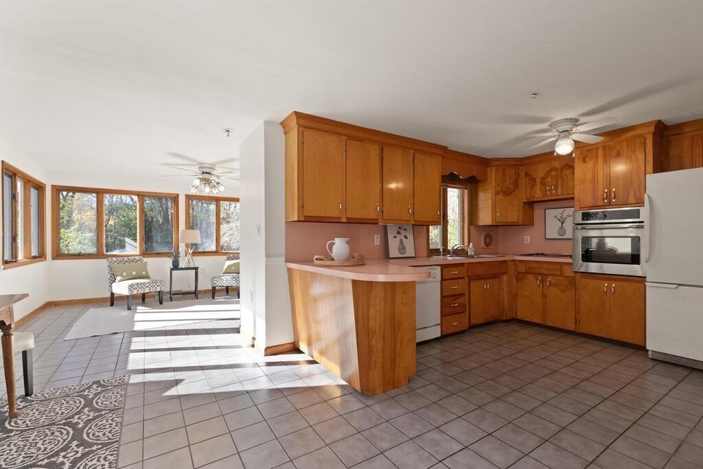 34 Locust Street Burlington, MA 01803 - Photo 8 of 24 a kitchen with granite countertop a refrigerator and cabinets