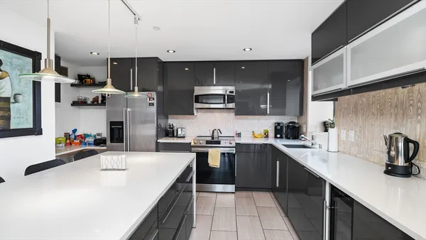 a kitchen with a sink a stove and cabinets