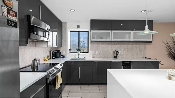a kitchen with a sink a stove and cabinets