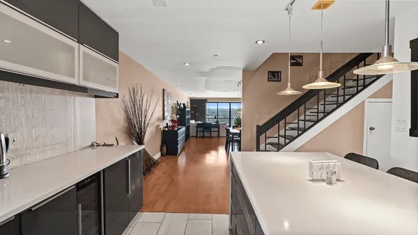 a hallway with lots of wooden cabinets and appliances