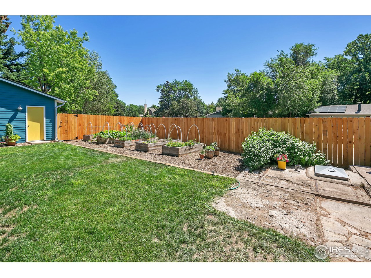 1500 West Prospect Road Fort Collins, CO 80526 - Photo 26 of 34 a view of backyard with potted plants and wooden fence