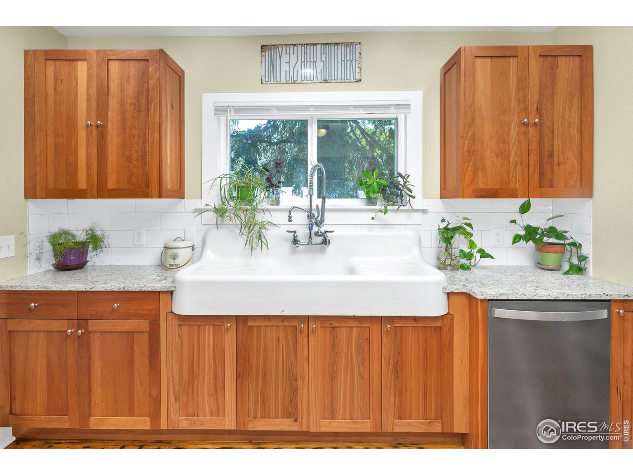 1500 West Prospect Road Fort Collins, CO 80526 - Photo 10 of 34 a kitchen with a sink a window and cabinets