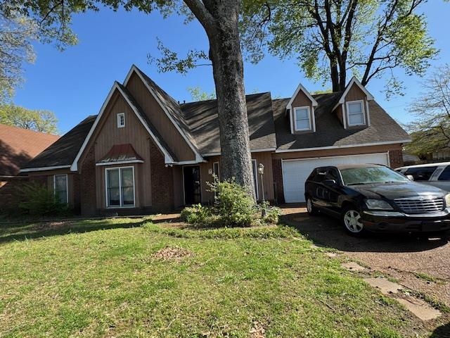 7347 Richmond Road Memphis, TN 38125 - Photo 1 of 1 View of front of house with a garage and a front yard